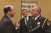 Police Chief John Gardiner, right, speaks to OPP Sgt. Paul Legault, while OPP Supt. Carson Pardy, centre, looks on during the April 10 finance, administration and operations committee meeting.